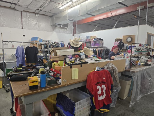 Volunteers sorting donated clothing and household goods at Mustard Seed